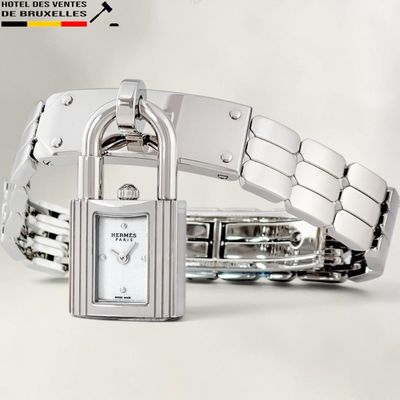 a silver bracelet with a padlock on it that is attached to a watch