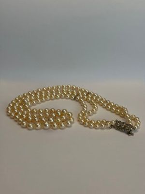 gros plan d'un collier de perles sur une surface blanche