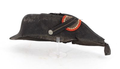 an old black hat with a red circle on the side of it