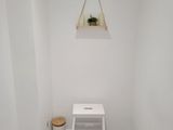 a small white chair in the corner of a room