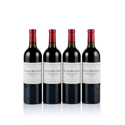 three bottles of red wine sitting next to each other on a white surface