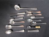 a lot of spoons and spoon knives on the table