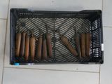 a basket full of hot dogs on a tile floor