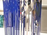 a sculpture of a group of people standing in front of each other