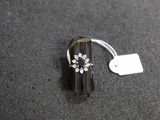 a ring with a flower on it sitting on a table