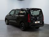 the small black van is parked in a large room