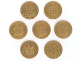 six old british coins on a white surface
