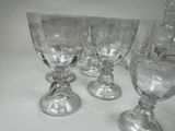 four wine glasses sitting on a table next to each other