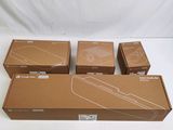 four boxes of nintendo wii controllers sitting on a white surface