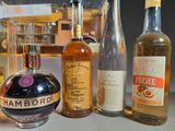 several bottles of alcohol are lined up on a counter