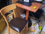 a desk with a chair and a laptop on it