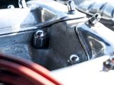 a close up of a motorcycle engine with a hose