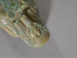 a close up of a statue of a fish on a white surface