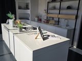 a white kitchen with a laptop on the counter