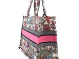 a close up of a bag with a pink stripe on it