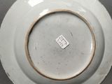a white plate with a brown rim sitting on a table