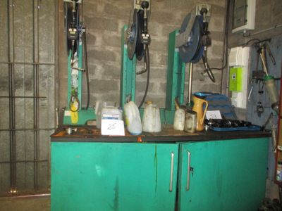 a green cabinet with a bunch of bottles on top of it