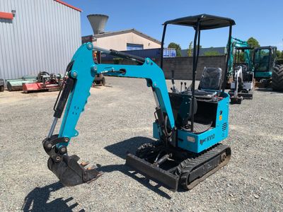 a small blue excavating machine parked in a parking lot