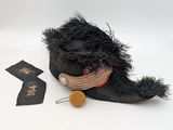 a stuffed animal that is laying on the ground next to a piece of cloth