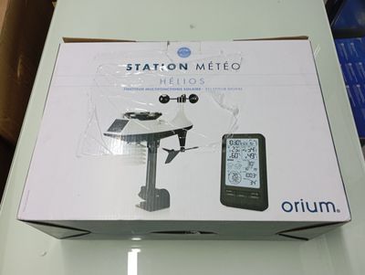 packaging of a box with a clock and a cell phone on a table