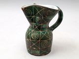 a green and brown vase with a spiral design on it