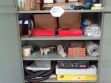 a cupboard with many items in it in a room