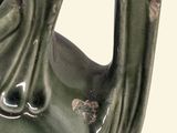 a green vase with a handle on a white background