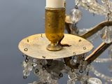 a candle that is sitting on top of a chandelier