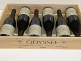 six bottles of red wine in a wooden box on a table