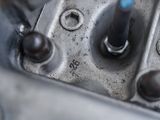 a close up of a metal object with a blue handle