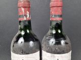 two bottles of wine are sitting next to each other on a table