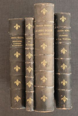 three old books are stacked on top of each other on a table
