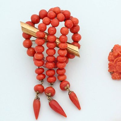two pieces of jewelry that are on a white surface