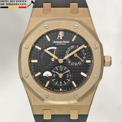 an image of a gold and black watch on a white background