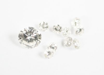 a close up of a bunch of diamonds on a white surface