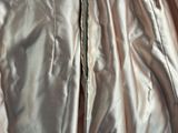 the jacket is shiny and has a zipper on the side