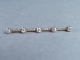 a close up of a diamond bar broocher on a table