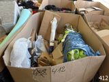 many boxes of clothes and other items in a room