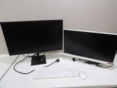 two computer monitors and a keyboard on a white desk
