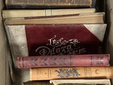 a lot of books in a box on the floor