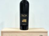 the bottle of wine is sitting on a wooden box