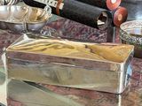 a glass table with a silver box on top of it