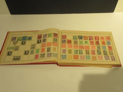 an open book with stamps on it sitting on a table