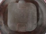 a metal container with a lid on a white surface