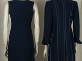 three mannequins of different sizes and colors of dresses on a mannequin stand