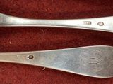 two spoons that are sitting next to each other
