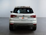 the rear end of a white suv parked in a room