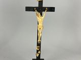 a black and gold crucif with jesus on the cross