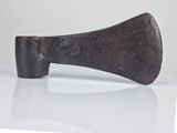 an old axe that is sitting on a white surface