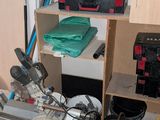 a small room with a lot of tools and a shelf